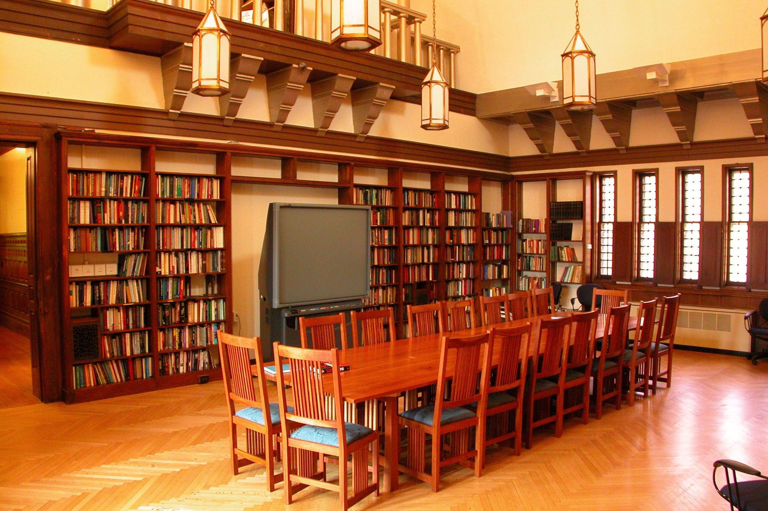 The ISPS library with hanging lantern-style lights, bookcases, and a balcony