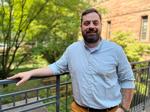 Ian Turner stands on the ISPS building's patio