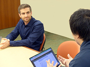 Joshua Kalla listens to a student in class