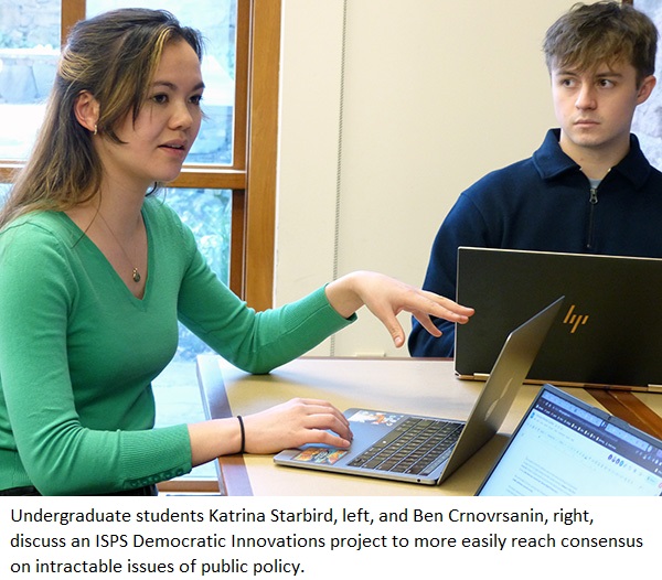 Undergraduate students Katrina Starbird, left, and Ben Crnovrsanin, right, discuss an ISPS Democratic Innovations project to more easily reach consensus on intractable issues of public policy.