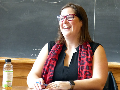 Emily Cain smiling at a table