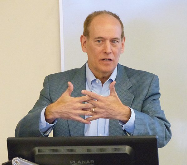 Steven Vogel speaks behind a lectern in a classroom