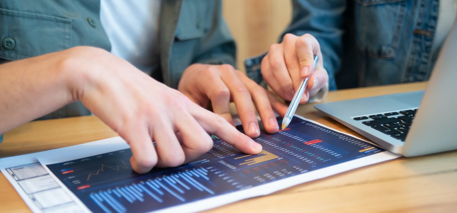 image of two people working on research materials