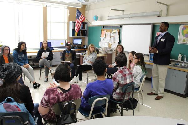 Adrian Hale speaks in a classroom