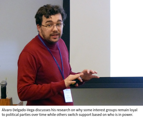 Alvaro Delgado-Vega speaks in a classroom in front of a projection screen