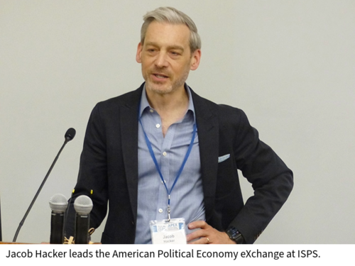 Jacob Hacker speaks from behind a lectern in a classroom.