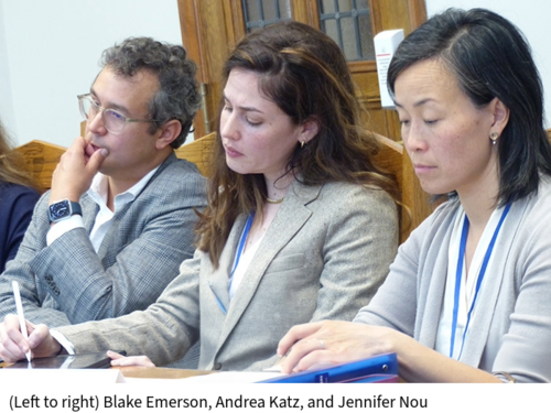 Blake Emerson, Andrea Katz, and Jennifer Nou listen at a table in a classroom