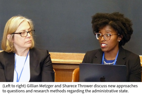 Gillian Metzger and Sharece Thrower speak at a table in a classroom.