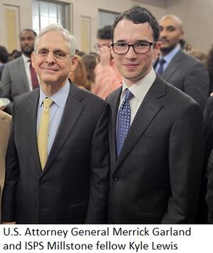 Attorney General Merrick Garland and Kyle Lewis pose in a crowded room