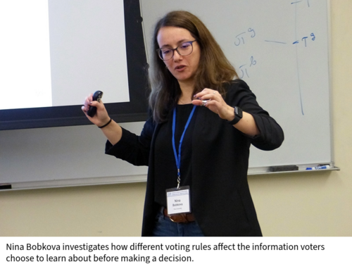 Nina Bobkova speaks in a classroom in front of a projection screen