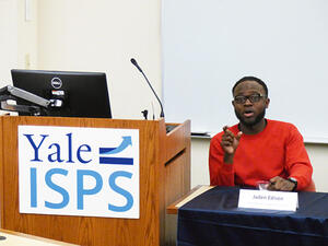 Jaden Edison speaks next to a Yale ISPS lectern