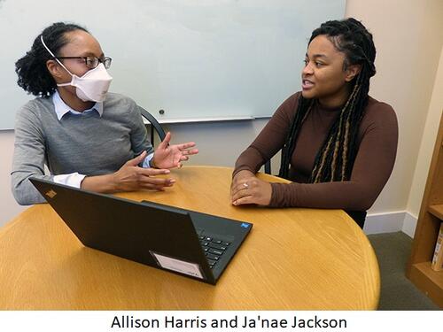 Allison Harris and Ja'nae Jackson talk while seated at a table in an office