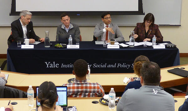 Jacob Hacker, Alexander Hertel-Fernandez, K. Sabeel Rahman, and Cristina Rodriguez sit at a panel table in a classroom
