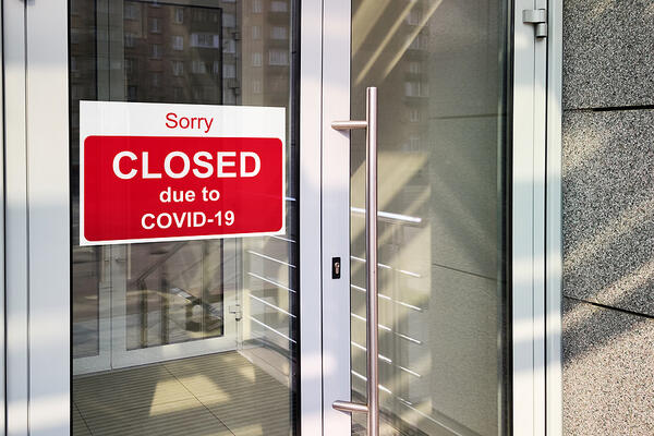 A sign on a store reads &quot;Sorry, closed due to COVID-19&quot;