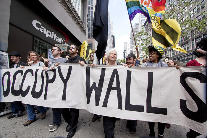 Protesters march past a Capital One bank on their way to Union Square from Bryant Park during Occupy Wall St 'May Day' protests on May 1, 2012 in New York, NY.