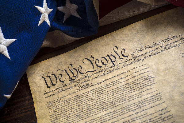 The constitution of the United States of American with a vintage flag