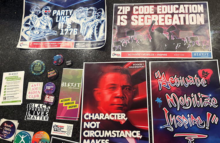 Last year's Turning Point USA conference in Phoenix featured speakers and materials designed to appeal to non-white voters. Includes a poster of Booker T. Washington with the quote "Character, not circumstance, makes the person" and another that says "Zip code education is segration"