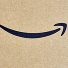 Close-up of an Amazon delivery package with the black curved arrow logo